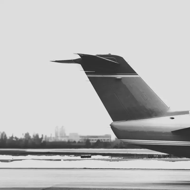 black and white close up shot of a private jet tail on a tarmac