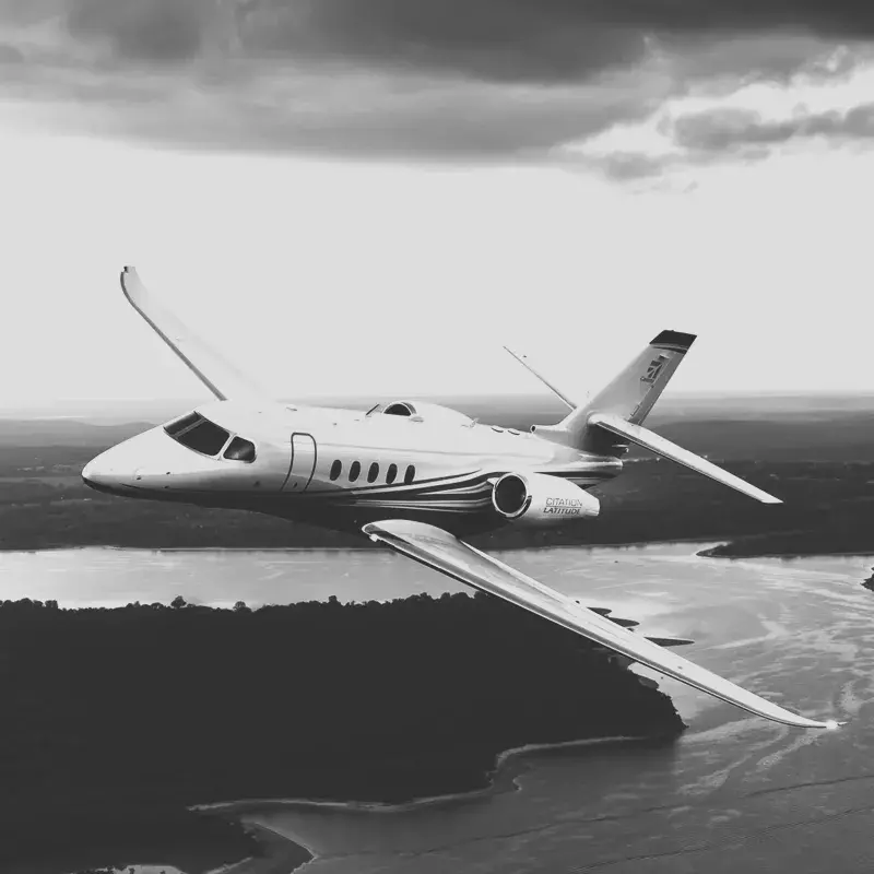 Cessna Citation Latitude in air flying above a river